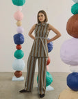 Juno Pant by Hunter Bell NYC in an art gallery with vibrant paper spheres, showcasing modern style.