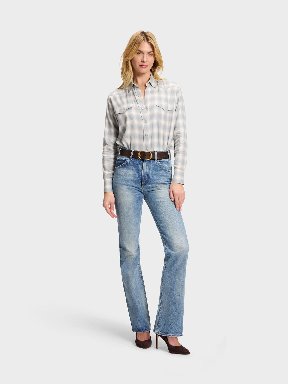 Plaid Sarah Alexandra, LLC Western shirt tucked into blue jeans with a brown leather belt and dark heels.