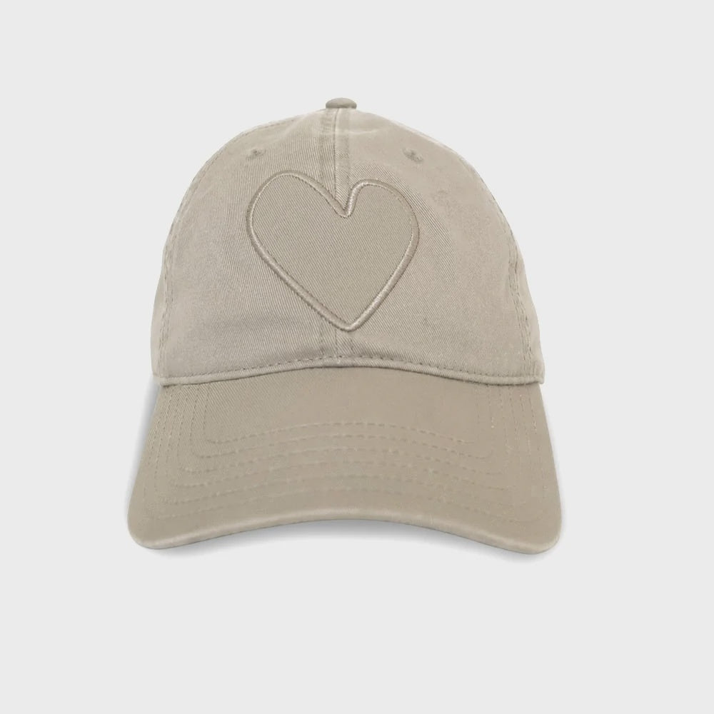Introducing the KR Imperfect Heart Hat by Kerri Rosenthal—a beige 100% cotton baseball cap with a raised heart design, curved brim, and six-line stitching that contrasts beautifully against a plain white background; a must-have for collectors.