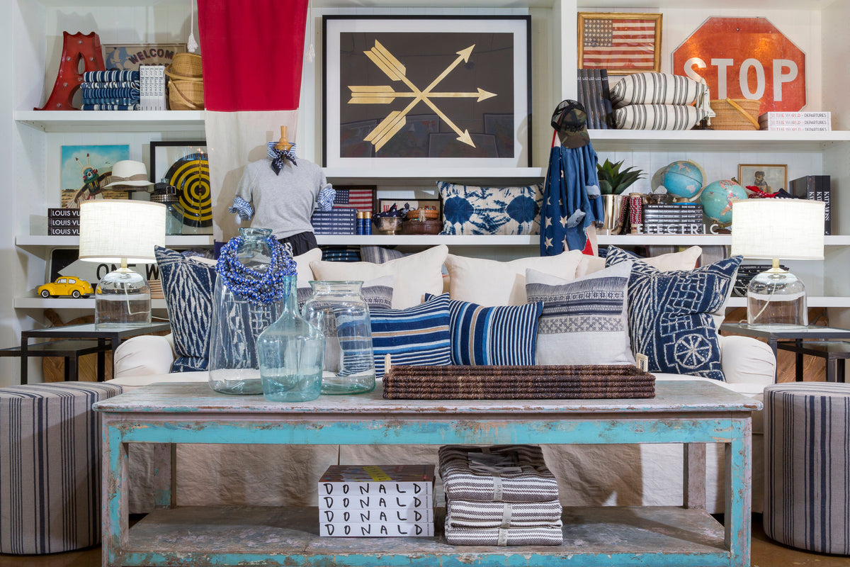 Blue-and-white eclectic living room featuring striped pillows and vintage-inspired decor by Bungalow Furniture & Accessories.