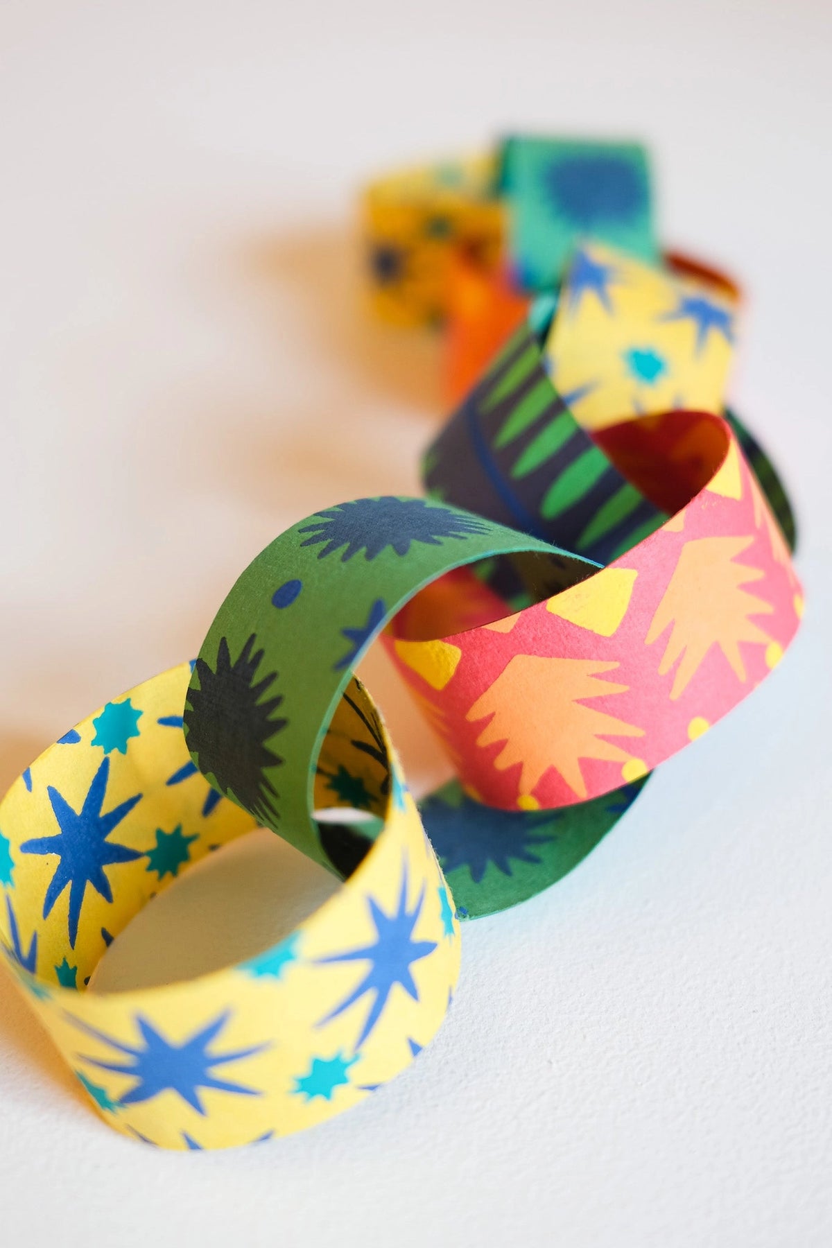 Colorful star and burst paper garland by Faire, perfect for festive birthdays, parties, or joyful celebrations.