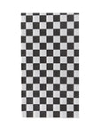 Check It! Check Guest Napkins by Faire feature a black and white checkerboard pattern with evenly sized squares arranged in alternating rows, reminiscent of skater shoe designs.