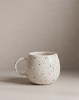 White Ball stoneware mug with a colorful speckled pattern by Bungalow Furniture & Accessories.