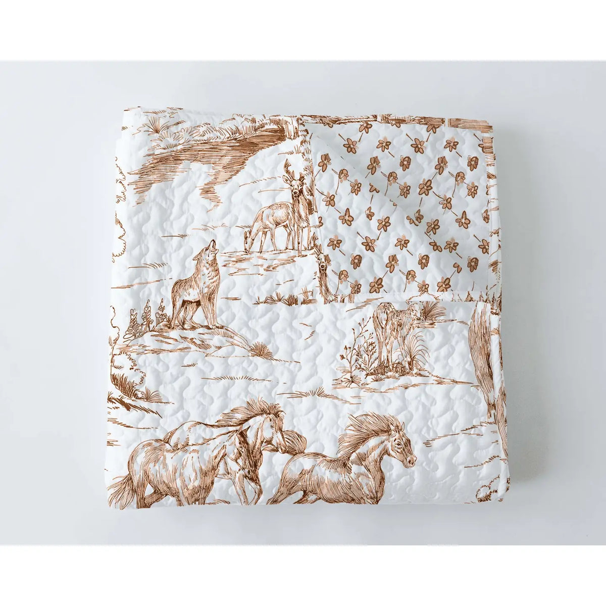 The Faire Buffalo Toile Brown Quilt features brown wildlife and floral illustrations on white, offering a vintage look with horses and coyotes—perfect for adding charm to your bedding collection.