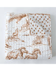 The Faire Buffalo Toile Brown Quilt features brown wildlife and floral illustrations on white, offering a vintage look with horses and coyotes—perfect for adding charm to your bedding collection.