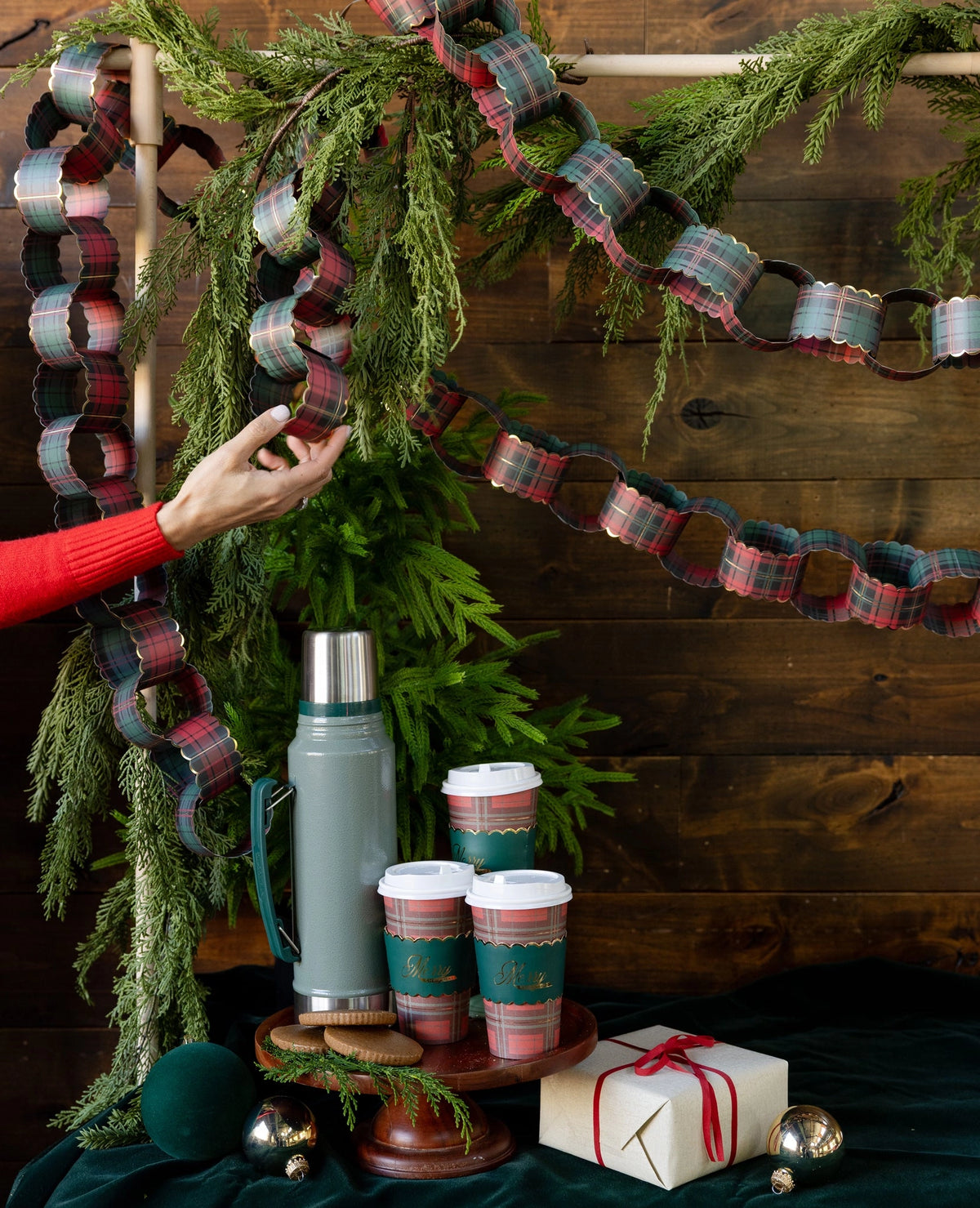 20ft Red and Green Plaid Christmas Paper Chains decorating cedar branches at Bungalow Furniture & Accessories.
