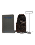 A grey "Steel Castings Handbook," a worn brown leather glove, and a Faire Desk Wire Display Stand L shaped like a 'T' are arranged side by side against a white background.