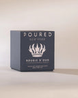 Dark blue Faire Bougie D’oud candle with rich oud and vegan ambergris on a light surface, Bungalow Furniture.