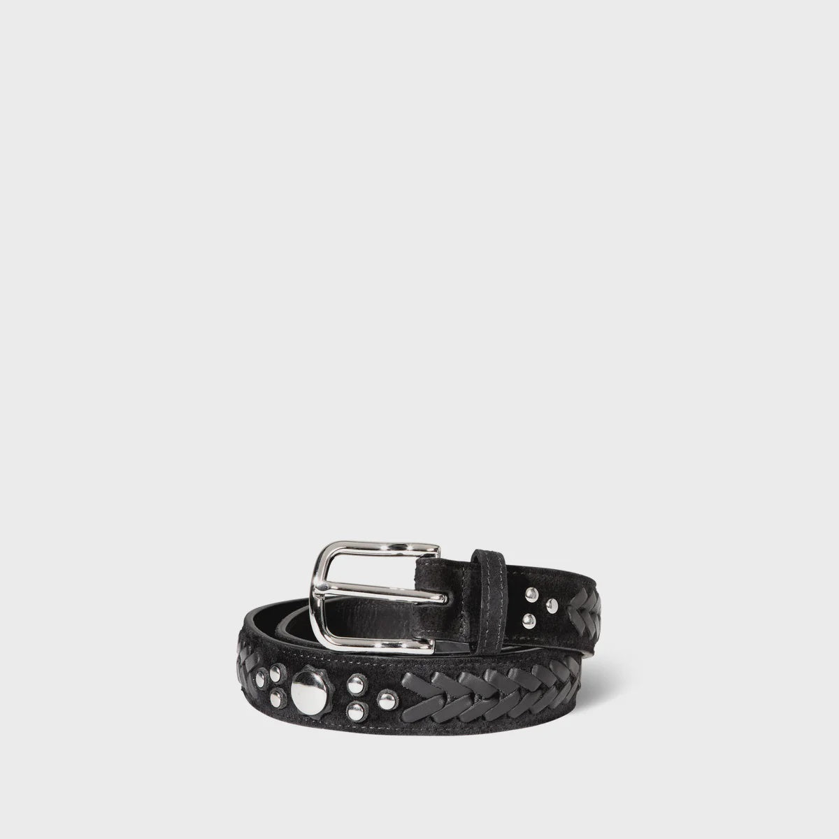 The Gaucho Ceinture belt by Jerome Dreyfuss features black cowskin leather with a silver buckle, blending braided and studded details. This adjustable accessory is rolled up against a plain white background.