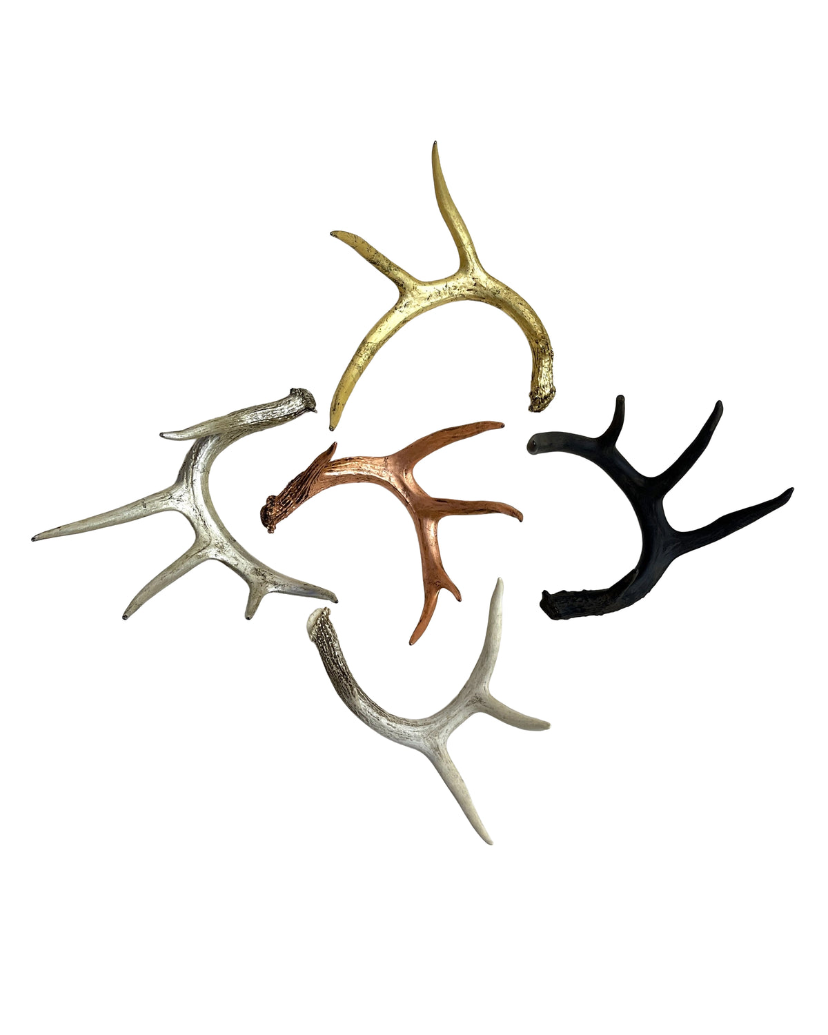 Set of five metallic antler accents by Faire in gold, silver, copper, black, and bronze for coffee table decor.