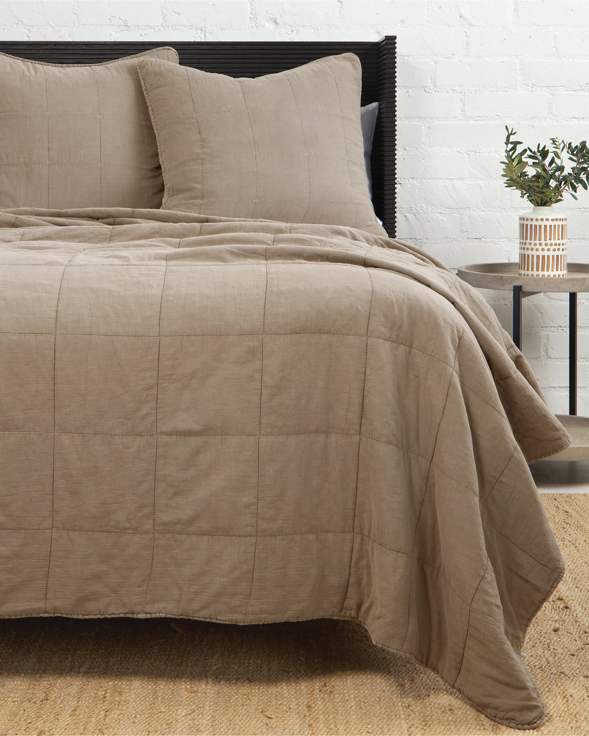 Antwerp Coverlet King by POM POM displayed on a bed in a cozy, natural bedroom setting with woven accents.