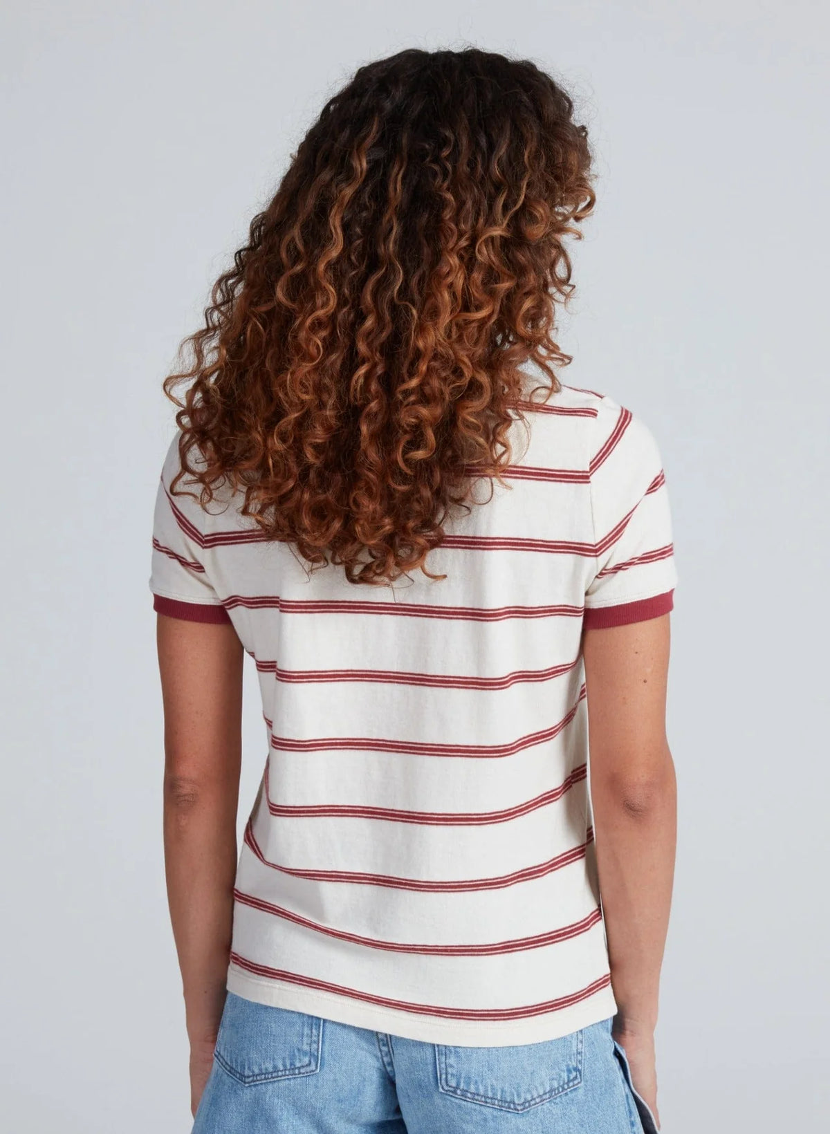 ASKK Classic Ringer Tee in white with blue trim, styled with blue jeans, shown from the back against a neutral background.
