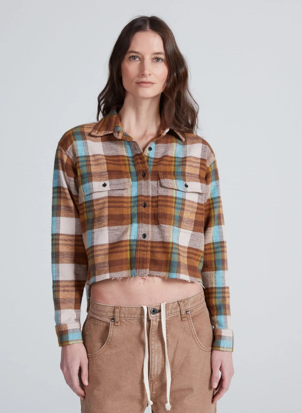 ASKK Crosby Les Plaid flannel shirt, cropped fit, paired with beige pants, neutral backdrop, casual style.