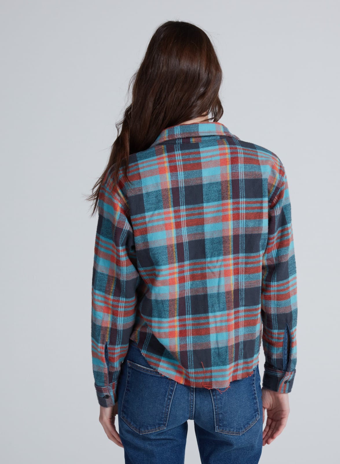 ASKK Crosby Flannel shirt in a plaid pattern, modeled from behind, paired with jeans.