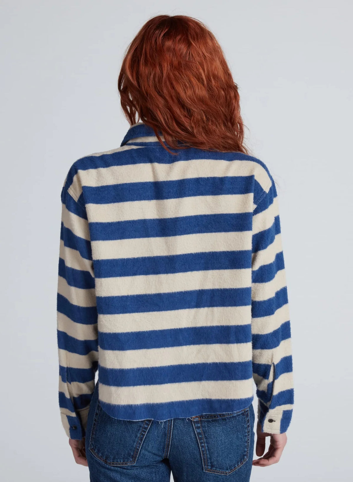ASKK Crosby shirt in blue and cream relaxed fit tucked into blue jeans, back view.
