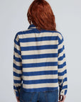 ASKK Crosby shirt in blue and cream relaxed fit tucked into blue jeans, back view.