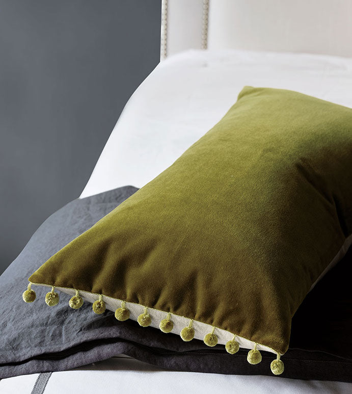 Olive green cotton velvet lumbar pillow with pom-poms, Citrine Frou Frou Pillow 15x26 from Bungalow Furniture &amp; Accessories.