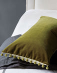 Olive green cotton velvet lumbar pillow with pom-poms, Citrine Frou Frou Pillow 15x26 from Bungalow Furniture & Accessories.