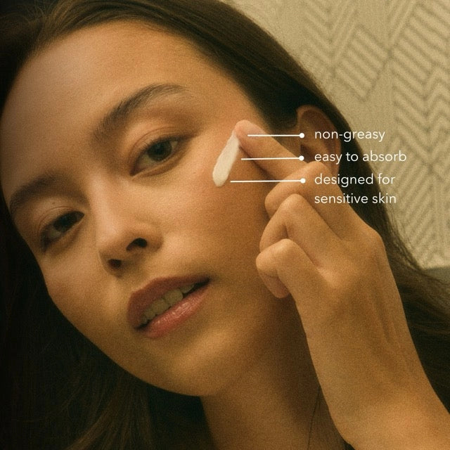 A woman applies Faire Vaca Skin Redness Recovery cream to her cheek. Text reads "non-greasy," "fast-absorbing," and "for sensitive skin with Centella Asiatica." The background features a subtle geometric pattern.