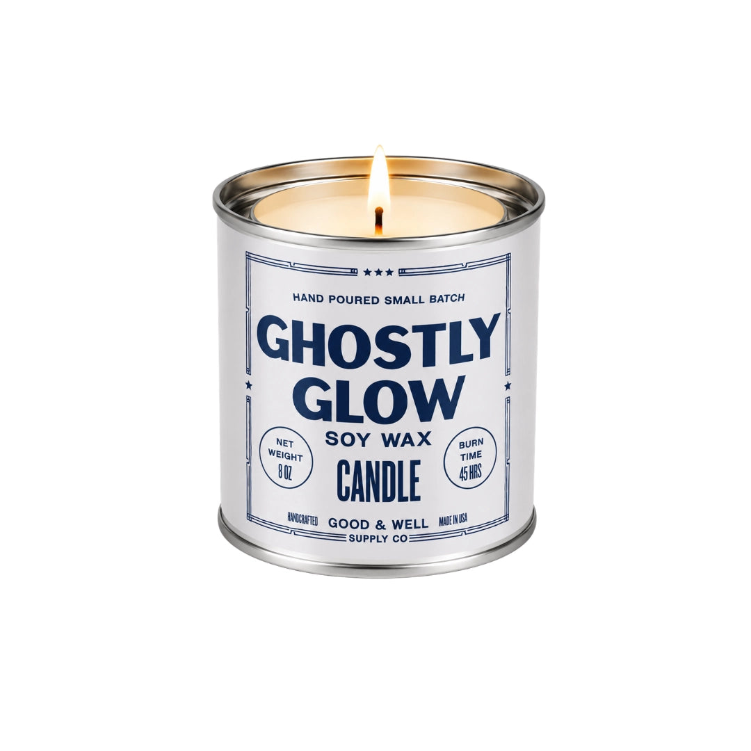 Ghostly Glow soy candle in a silver tin by Faire with cardamom, honey, and vanilla scents, perfect for Halloween ambiance.