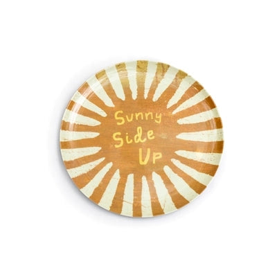 The Breakfast Club Plate Set by Sugarboo Designs features a round plate with yellow and white sunburst rays and "Sunny Side Up" in a playful font—ideal for your breakfast routine.