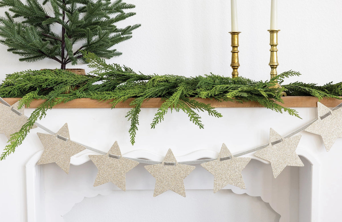 Chunky Silver Glitter Star Banner hanging on a festive fireplace mantel, Bungalow Furniture & Accessories.
