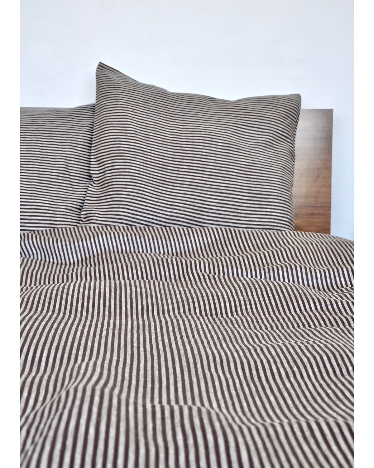 Baltic Queen Duvet by Modernplum on a neatly made bed with wooden headboard, minimal white bedroom style.