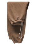 A pair of light brown BASIC GOODNESS OG SWEATPANTS by Free City (sparrow, LLC), folded lengthwise, featuring visible elastic cuffs and a white drawstring at the waistband.