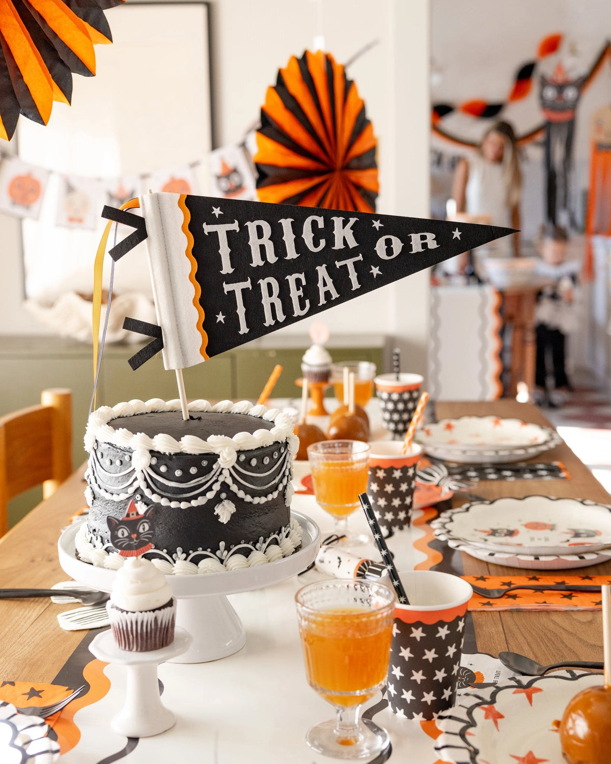 Black and white Halloween cake on styled table with vintage decor, Bungalow Furniture & Accessories ambiance.