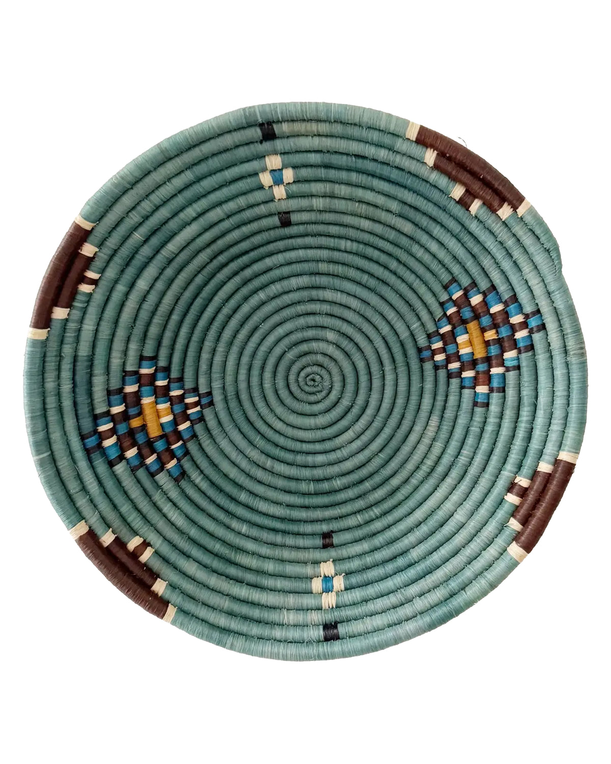 The Birava Large Bowl by Faire is a handmade, round woven tray with a teal spiral pattern, accented with geometric designs in brown, blue, white, and yellow spaced evenly around its edge.