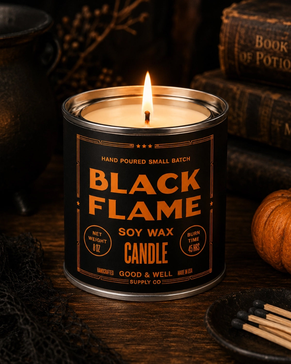 Faire Black Flame Soy Candle with oud scent, lit on a wood table in a cozy autumn setting, Bungalow Furniture & Accessories.