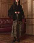 Western Fringe Sweater Jacket by The Great Inc. in a cozy living room with red couch and wood floors.