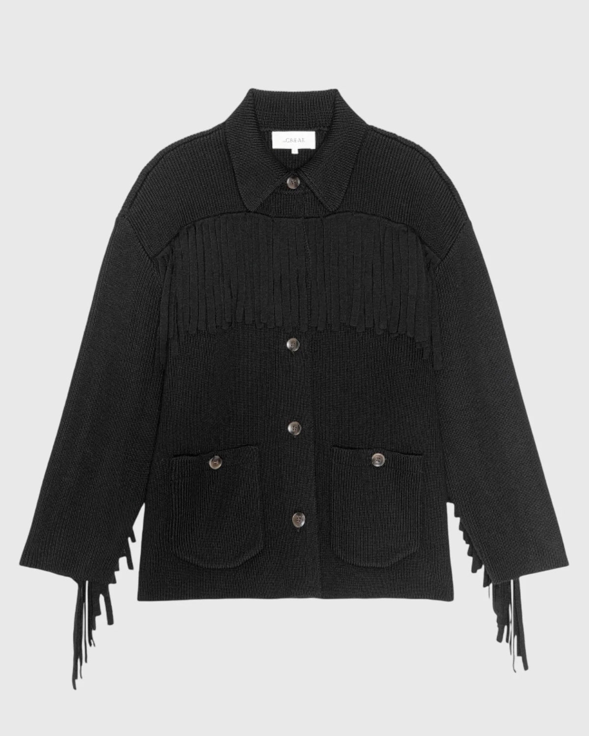 Chunky sweater jacket with fringe trim and front pockets by The Great Inc., heavyweight yarn, Western-inspired style.