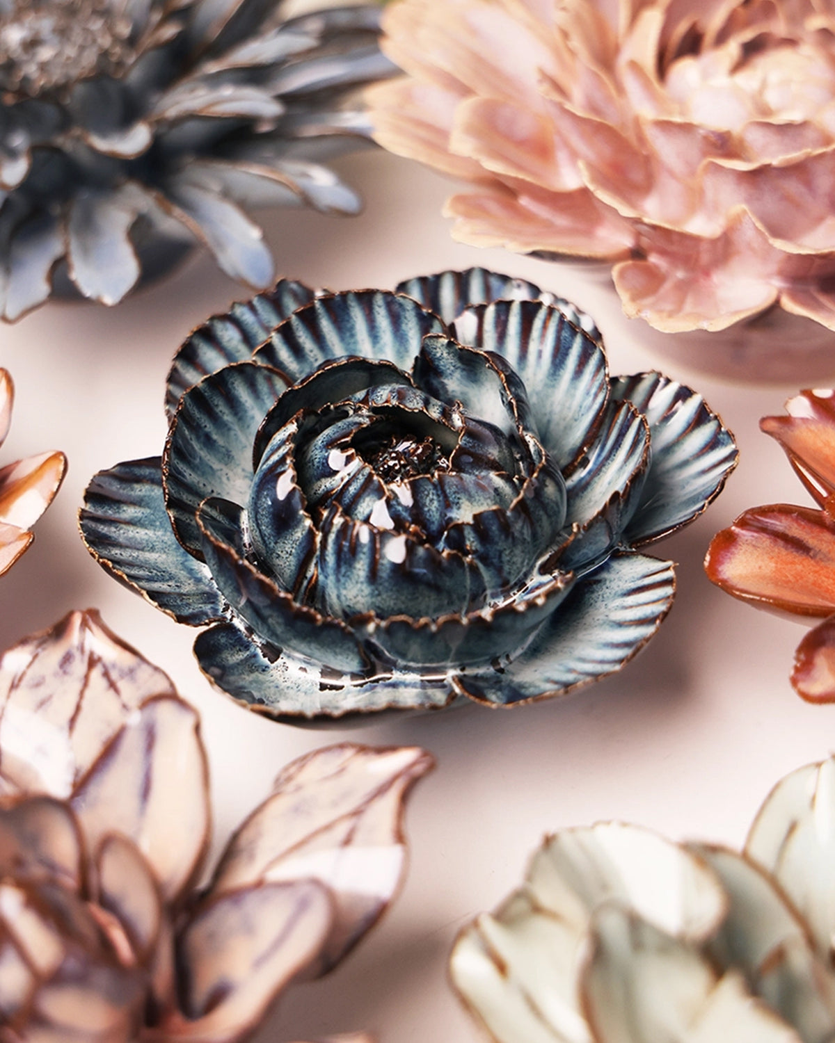Handcrafted ceramic Navy Cabbage Flowers with blue, pink, and white layered petals, by Bungalow Furniture &amp; Accessories.