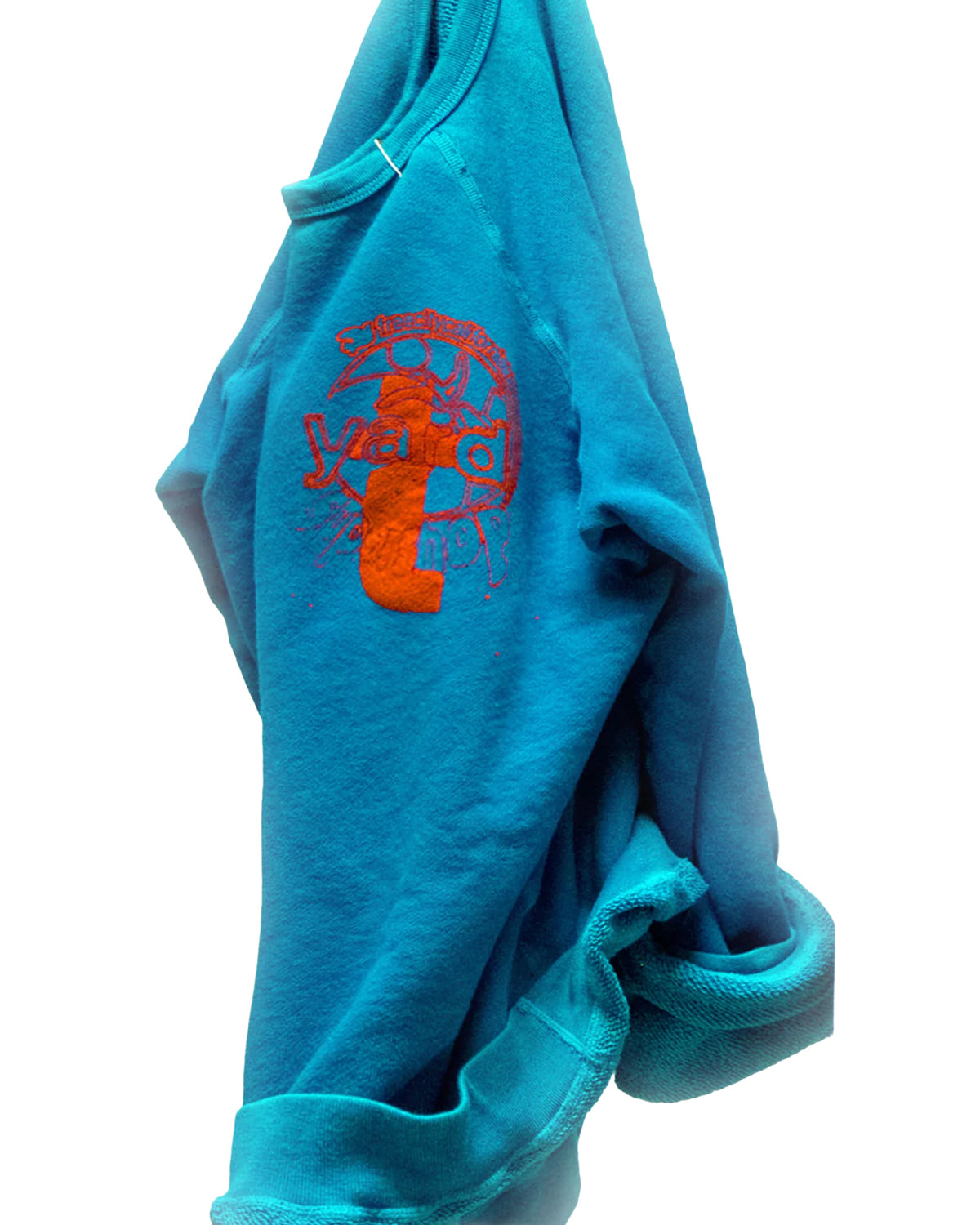 A blue French terry Artyard SUPERSHOP STAMP Raglan by Free City (sparrow, LLC) hangs against a white background, featuring orange and red "yard camp" graphics, visible sleeves and cuffs, and a slightly wrinkled finish.
