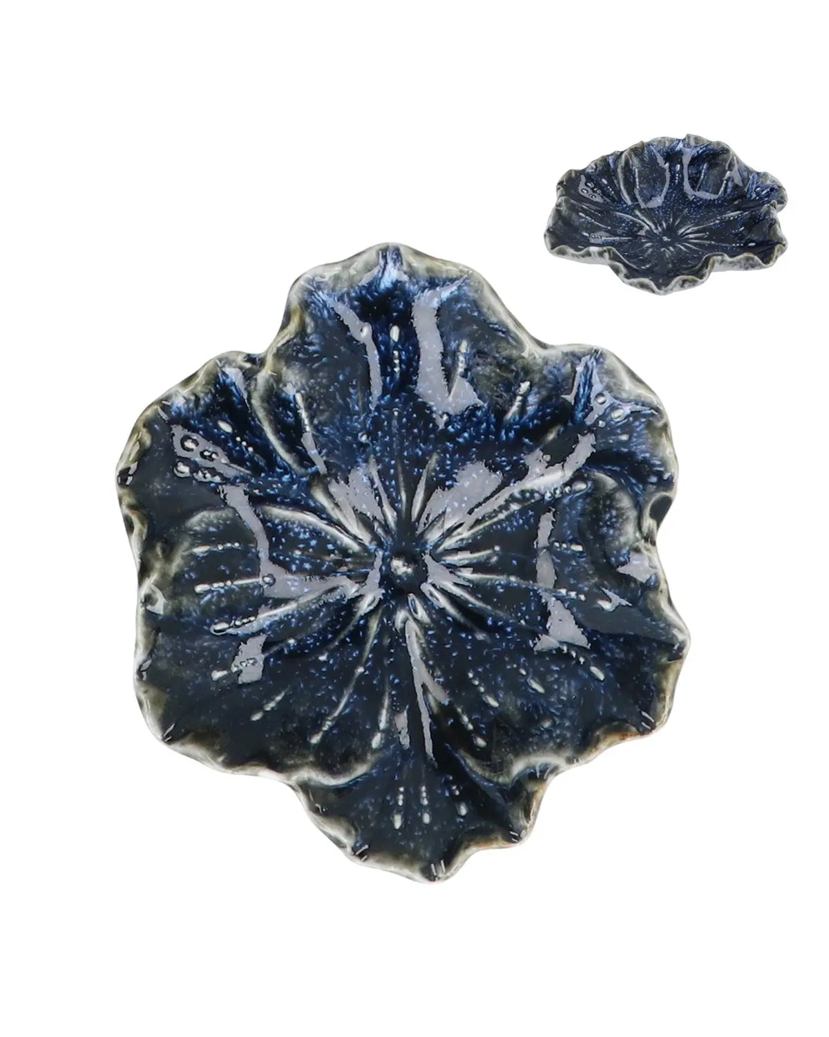 Two Blue Stoneware Hellebore Trinket Dishes by Faire—one large, one small—feature glossy, textured floral shapes, offering elegant home accents reminiscent of the Blue Reactive Stoneware style.