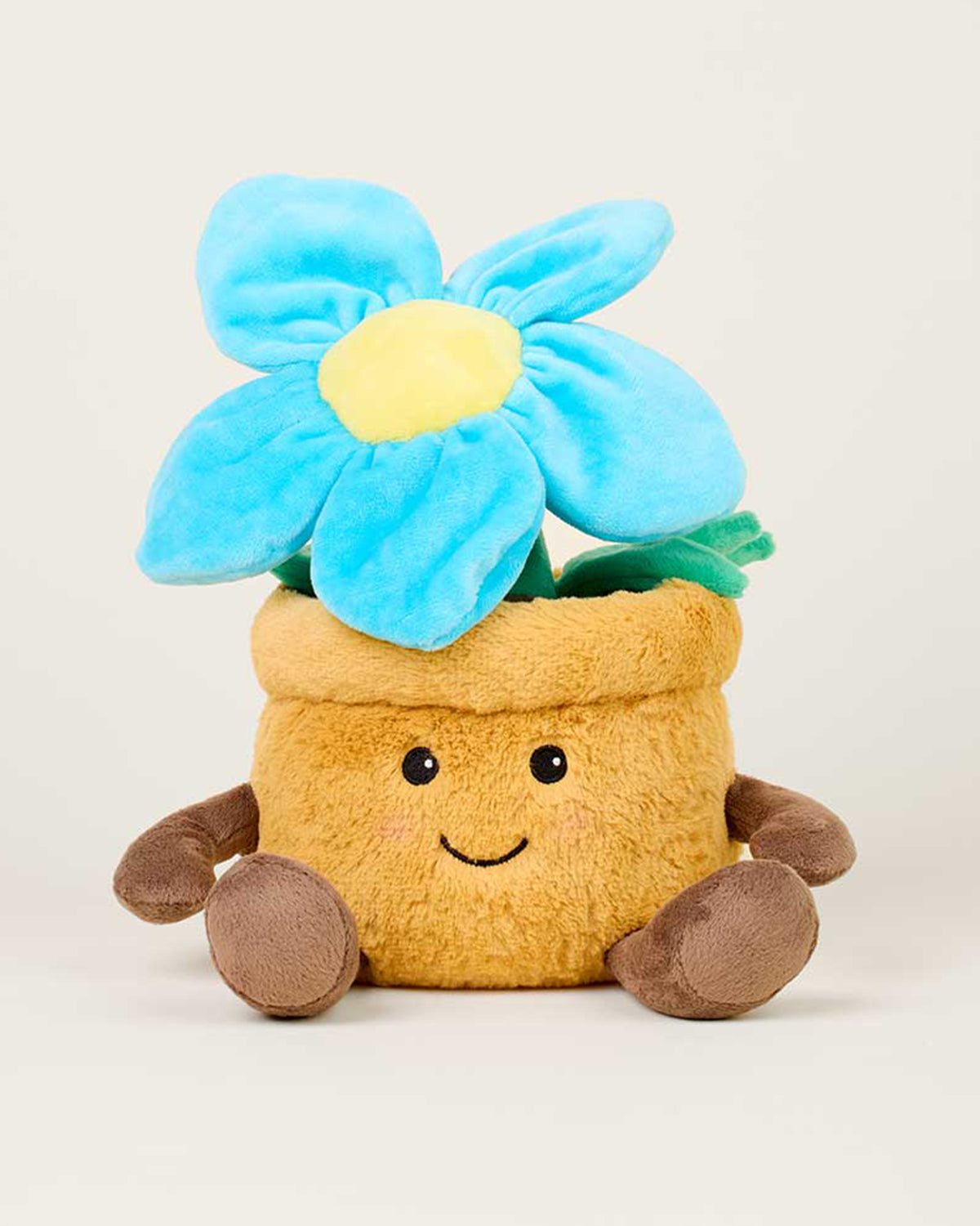 The Faire Blue Flower Pot Warmies is a plush toy shaped like a brown flower pot with a smiling face and blue flower, offering microwavable warmth and cuddly comfort.