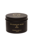 A black round tin of Cereria Molla Bulgarian Rose & Oud Candle features gold text "Cereria Molla 1899" and "Handmade in Spain" on the lid, shown against a plain white background.