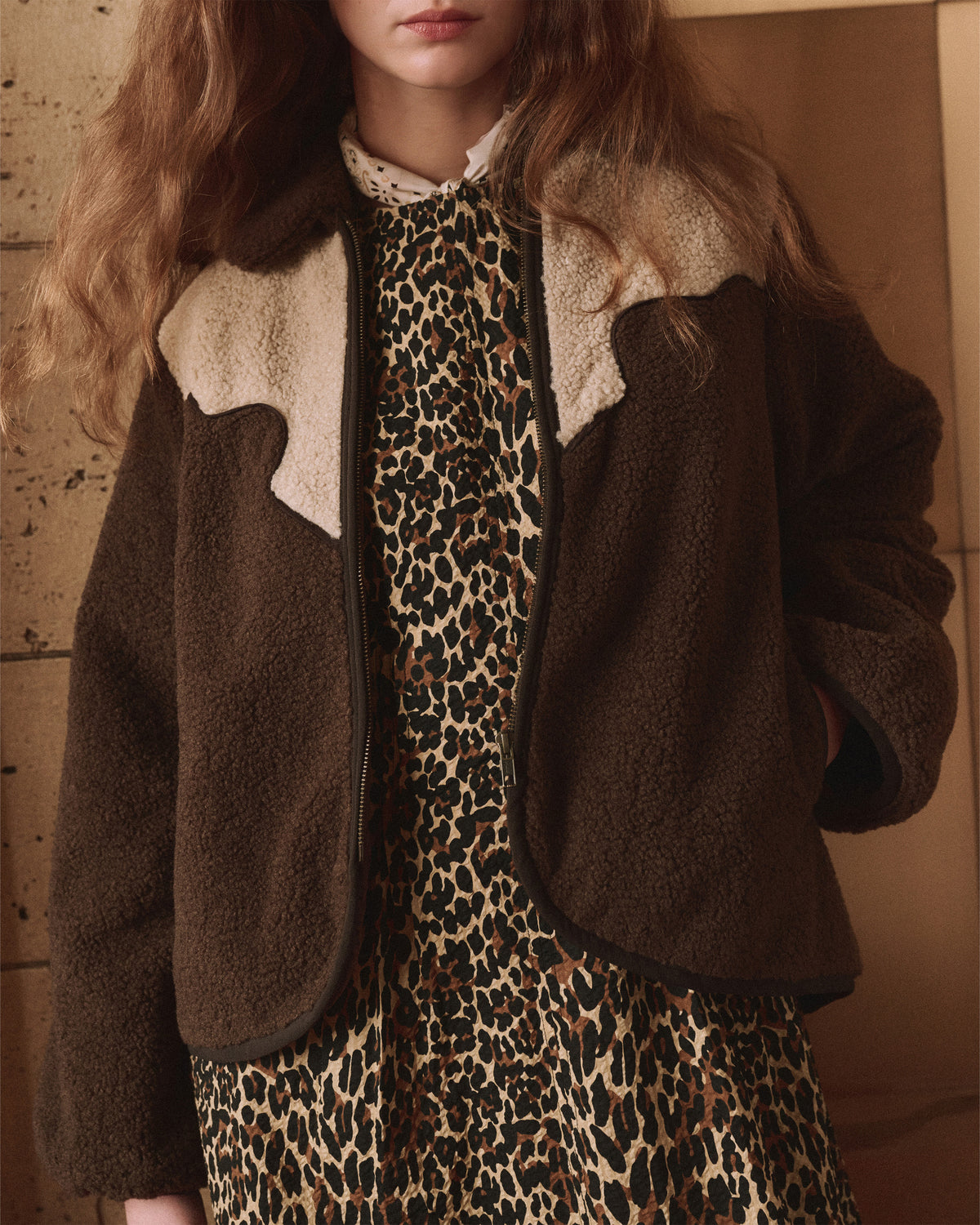 Leopard print dress with Reversible Western Yoke Pasture Jacket by The Great Inc., styled indoors in a modern setting.