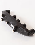 The Black Crescent Shape by Faire is a black, abstract ceramic sculpture with five rounded knobs, displayed on a white background. A small text label is attached to one side, making it a unique decor piece.