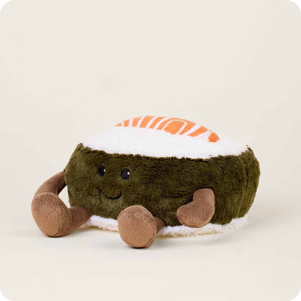 The Salmon Sushi Warmies by Faire is a microwavable plush toy shaped like a smiling salmon sushi roll, featuring brown arms and orange-white details on top.