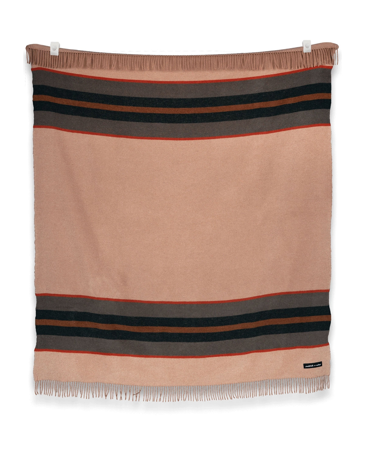 The S&A Blanket by Faire is a vintage-inspired rectangular beige throw with black and red stripes near the top and bottom and fringe detailing, shown laying flat against a white background.
