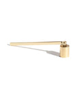 The Faire Candle Snuffer is a sleek, modern brass accessory with a long handle and cylindrical end, perfect for safely extinguishing candles. Elegantly displayed on a white background, it adds functional style to any home decor.