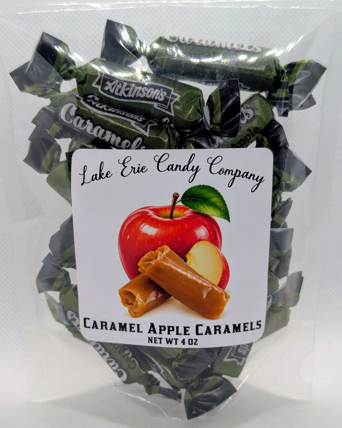 Faire Caramel Apple Caramels in dark green wrappers, packaged in a clear plastic bag.