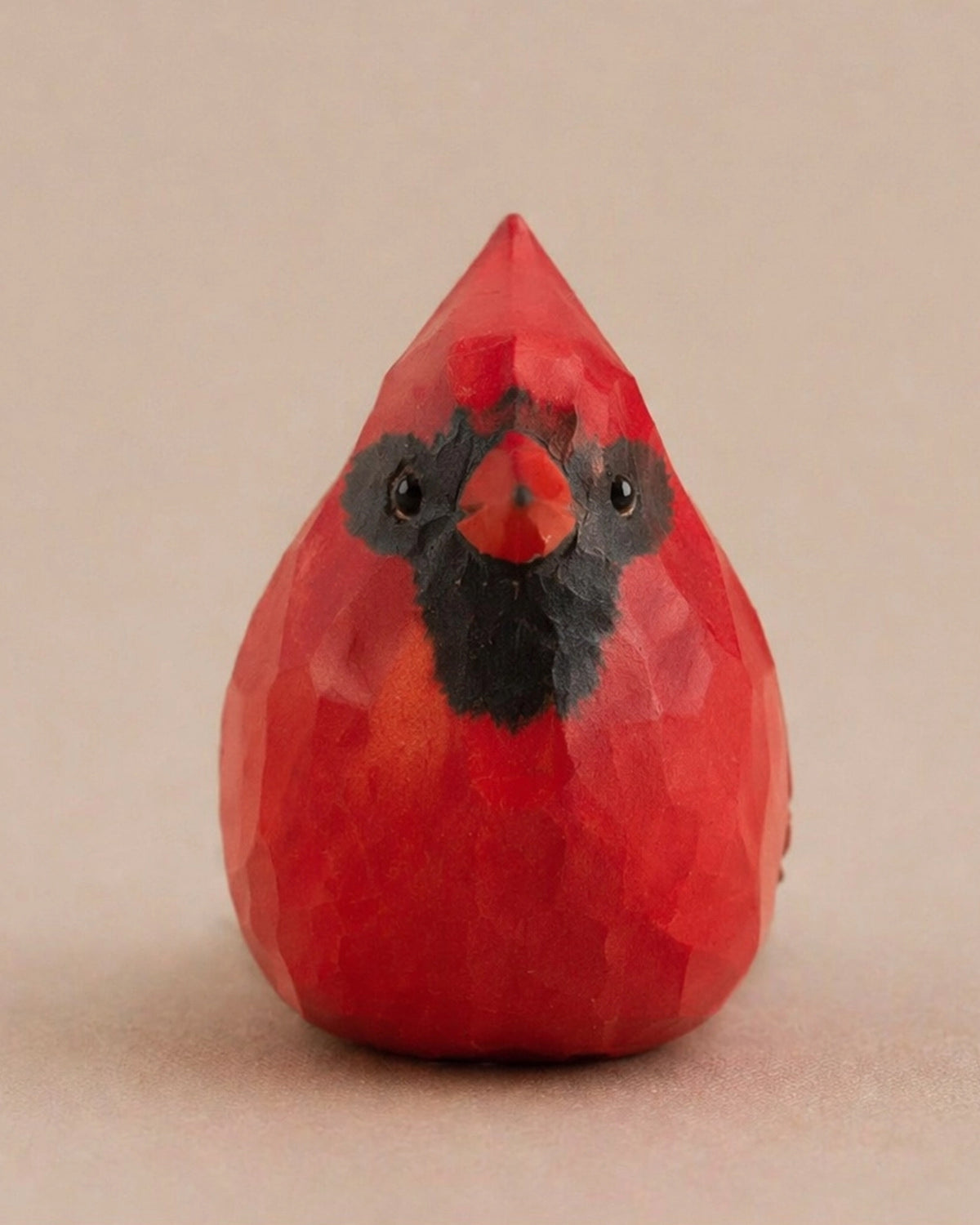 Red hand-painted carved wood bird with black accents, cardinal-inspired decor by Faire for Bungalow Furniture & Accessories.