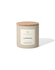 The 14oz. Cattleman candle by Faire features a beige jar with a wooden lid and minimalist label, hinting at its masculine soy fragrance. The jar casts a subtle shadow on a white background.