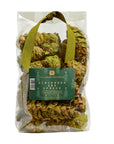 A clear plastic bag of Potpourri Pine Cones by Faire, featuring dried botanicals scented with pine and cedar, a green ribbon handle, and a green label on the front.