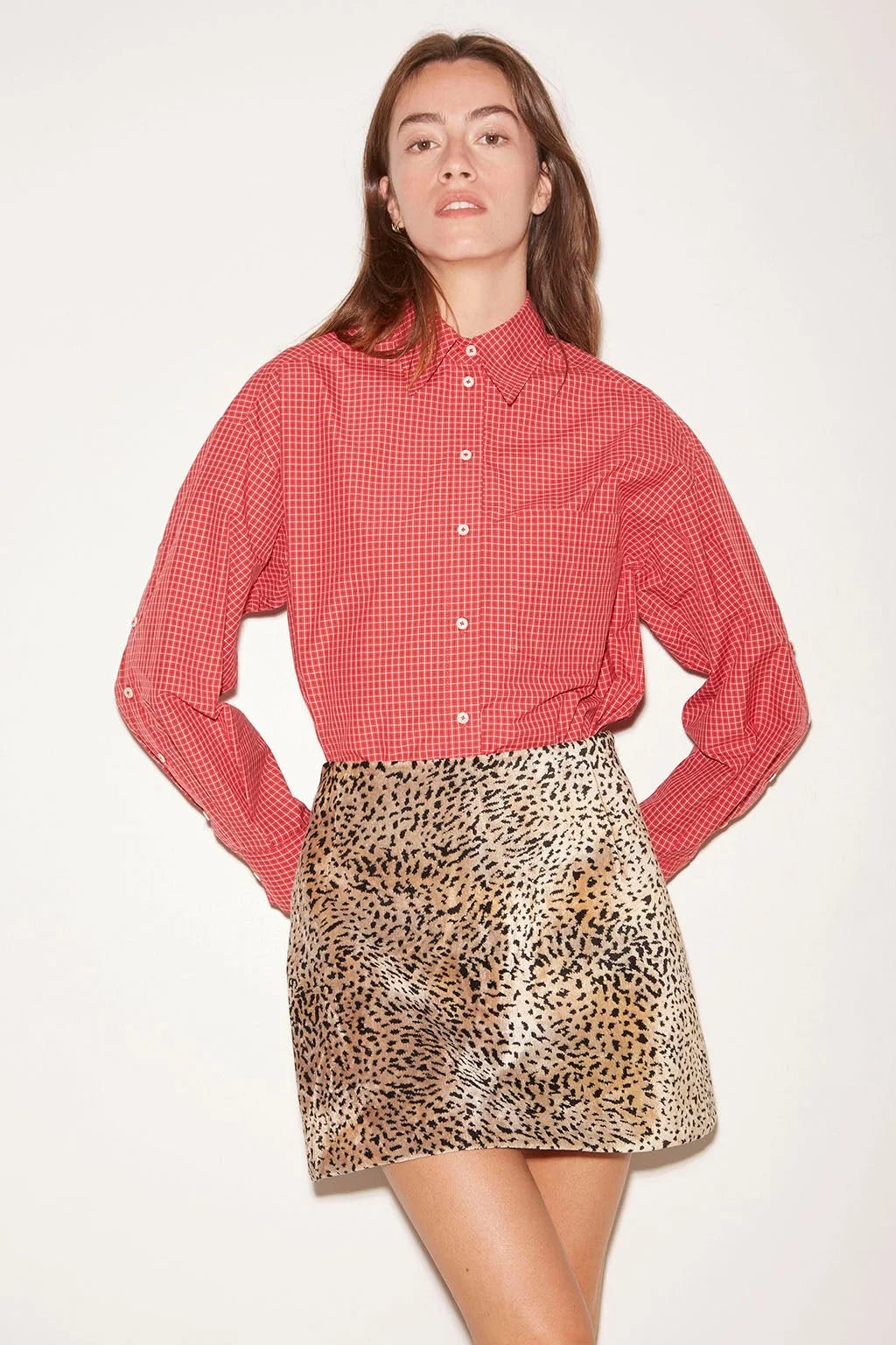 Red and white checkered Roseanna Chemise Shirt tucked into a leopard print mini skirt.