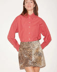 Red and white checkered Roseanna Chemise Shirt tucked into a leopard print mini skirt.