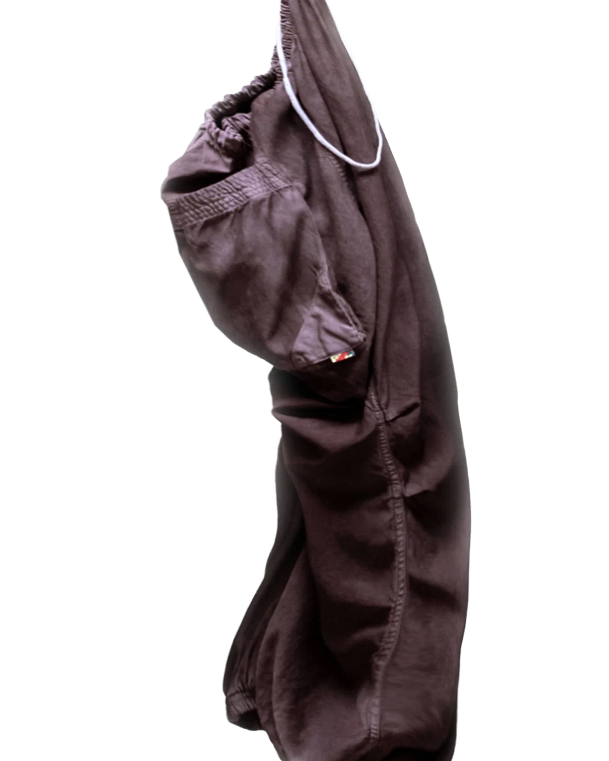 Dark brown satin loose drawcord pants by Free City hanging on a white background.